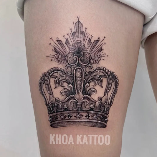 Medium Black and Grey Crown Tattoo on Women Thigh by @kat.tattooink