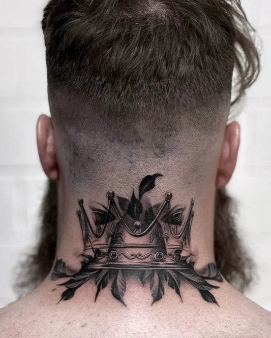 Medium Black and Grey Crown with Feathers Tattoo on Men Neck by @mikaelramgard