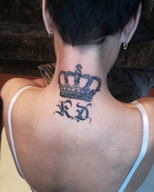 Medium Black and Grey Crown with KD Letters Tattoo on Women Neck by @kaspars_tattoo