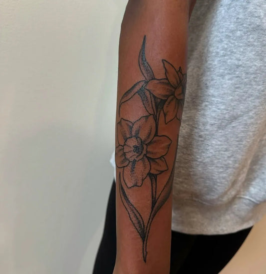 Medium Black and Grey Daffodil Tattoo on Women Arm by @fleetwood.kat.tattoo