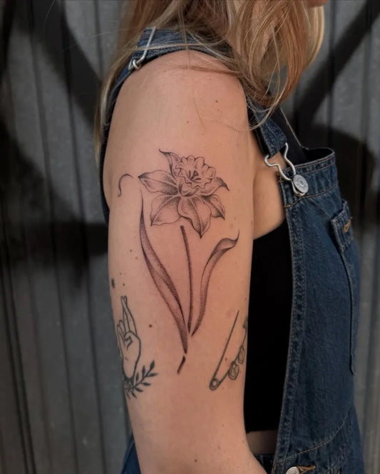 Medium Black and Grey Daffodil Tattoo on Women Arm by @nicnpoke