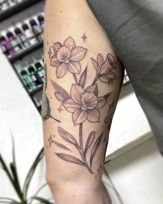 Medium Black and Grey Daffodil and Butterfly Tattoo on Women Arm by @alexstockwellart