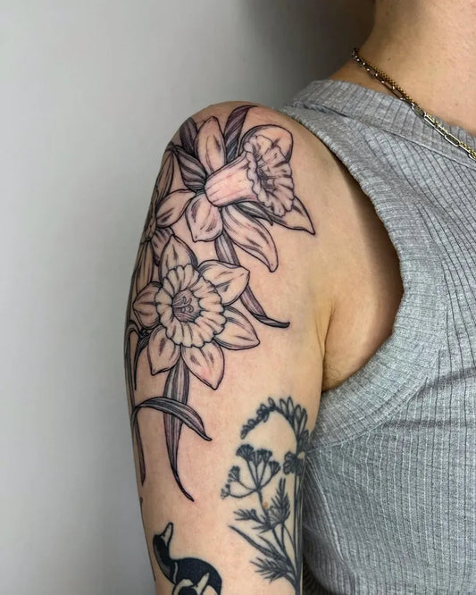 Medium Black and Grey Daffodil and Foliage Tattoo on Women Shoulder by @wiwientattoos