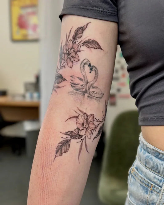 Medium Black and Grey Daffodil and Swan Tattoo on Women Arm by @samantha.tattoo
