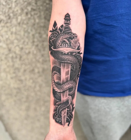 Medium Black and Grey Dagger Snake and Roses Tattoo on Men Arm by @dechillintattoo