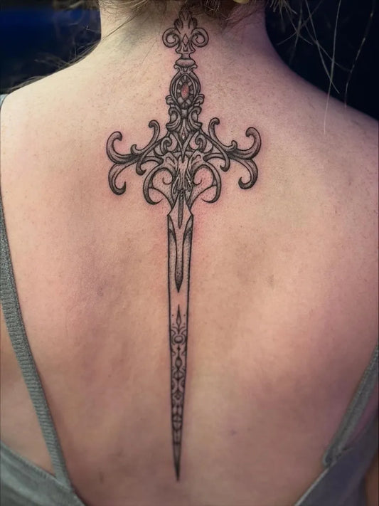 Medium Black and Grey Dagger Tattoo on Women Back by @gypsyskulltattoo