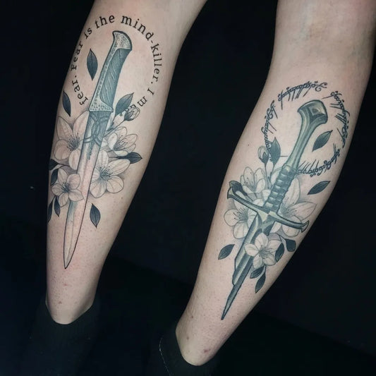 Medium Black and Grey Dagger and Flowers Tattoo on Women Leg by @theisenberg_tattoo666