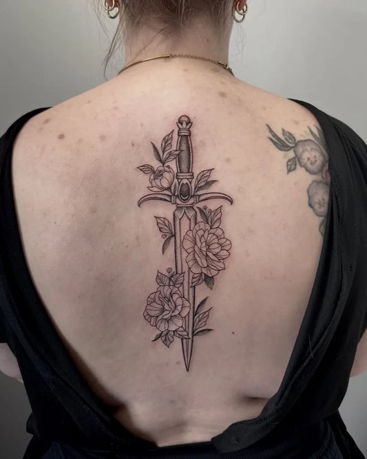 Medium Black and Grey Dagger and Peony Tattoo on Women Back by @mjbender.tattoos