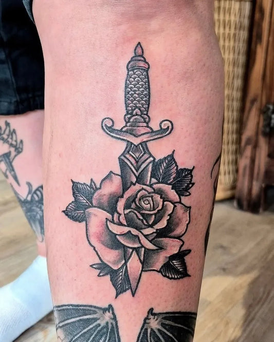Medium Black and Grey Dagger and Rose Tattoo on Women Thigh by @oldfaithful_tattoo