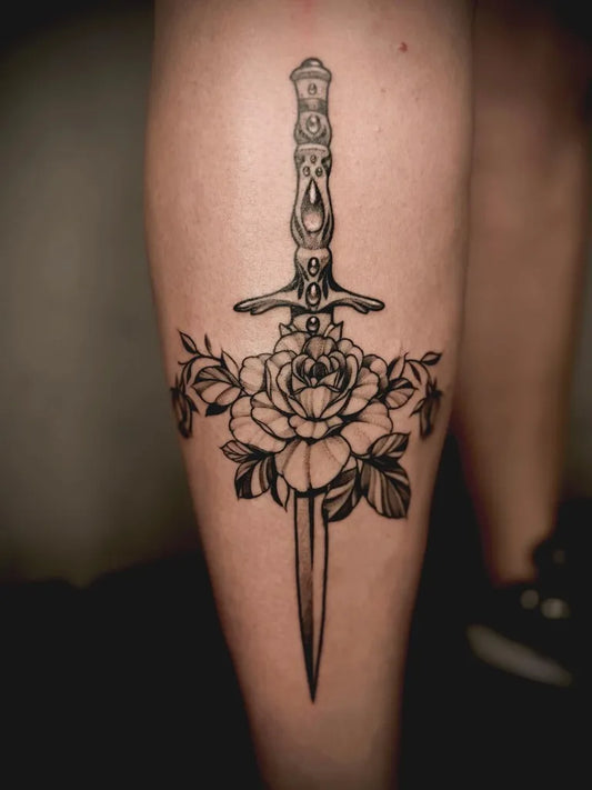 Medium Black and Grey Dagger and Roses Tattoo on Women Thigh by @86.inked