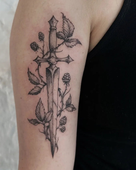 Medium Black and Grey Dagger with Blackberry Vines Tattoo on Women Arm by @ornatebones