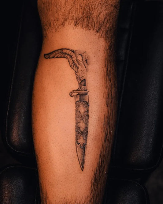 Medium Black and Grey Dagger with Wings and Skull Tattoo on Men Leg by @finnito