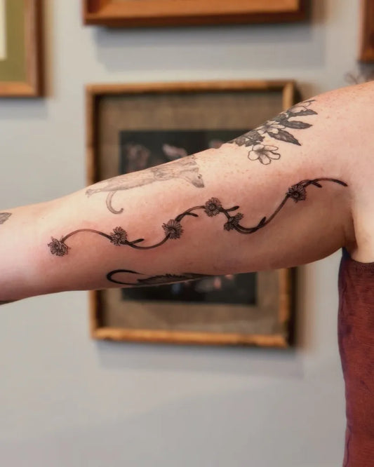 Medium Black and Grey Daisy Vine Tattoo on Women Arm by @guiltrippingg