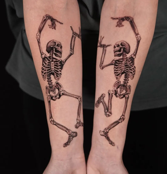Medium Black and Grey Dancing Skeletons Tattoo on Women Arms by @m.flueras