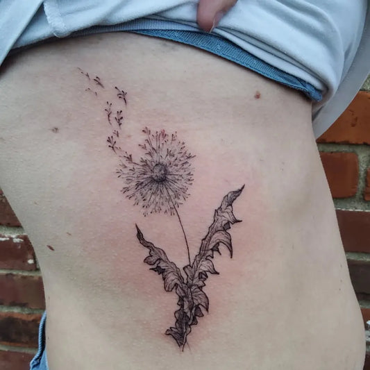 Medium Black and Grey Dandelion Tattoo on Women Rib by @extinction.ink
