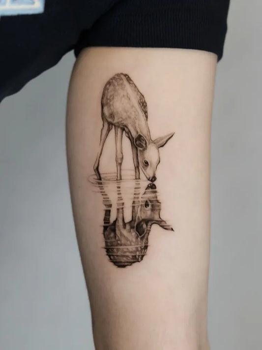 Medium Black and Grey Deer Reflection Tattoo on Women Arm by @szyna.ink