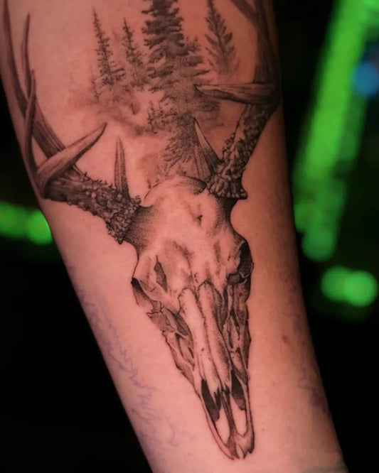 Medium Black and Grey Deer Skull with Forest Tattoo on Men Arm by @d_d_k_tattoos