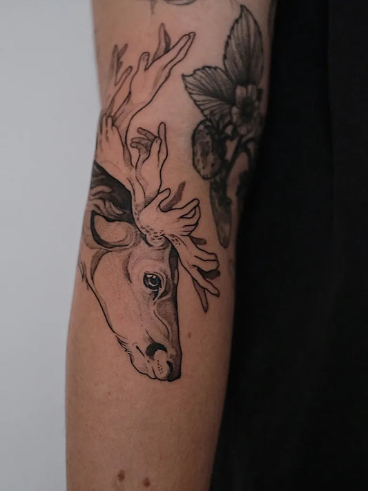 Medium Black and Grey Deer and Orchid Tattoo on Women Arm by @finn.j.tattoos