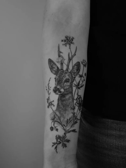 Medium Black and Grey Deer with Flowers Tattoo on Women Arm by @madlynevanlooy