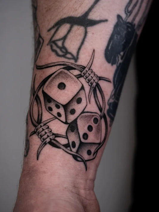Medium Black and Grey Dice and Barbed Wire Tattoo on Men Arm by @marcusgillot_tattoo
