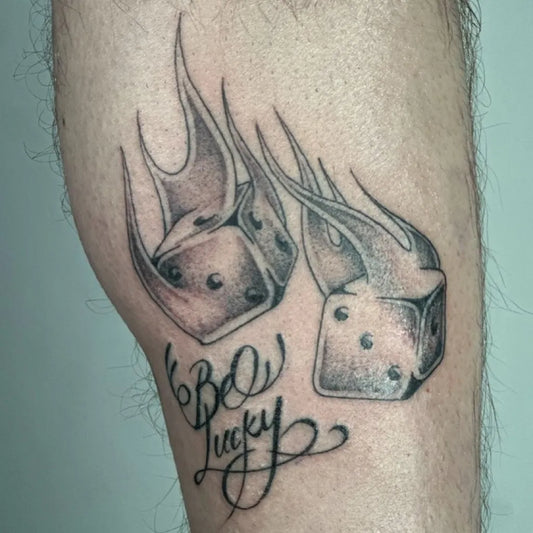 Medium Black and Grey Dice and Flames Tattoo on Men Thigh by @jobzy_tattoos