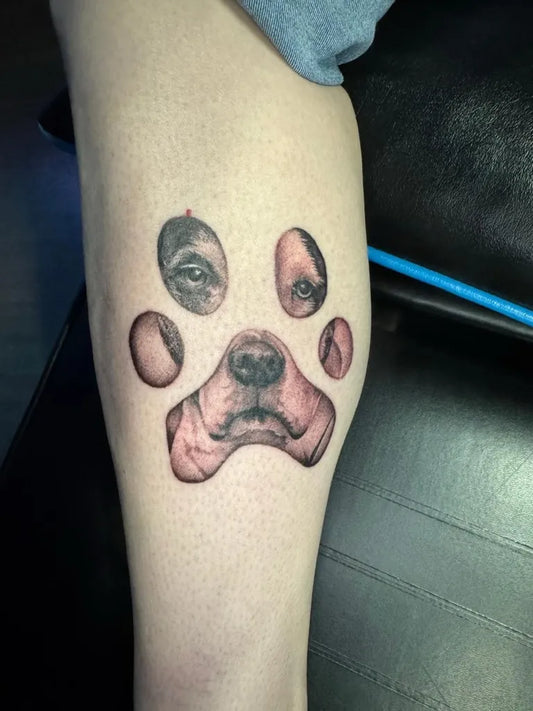 Medium Black and Grey Dog Face in Paw Print Tattoo on Women Leg by @blackarmpirate