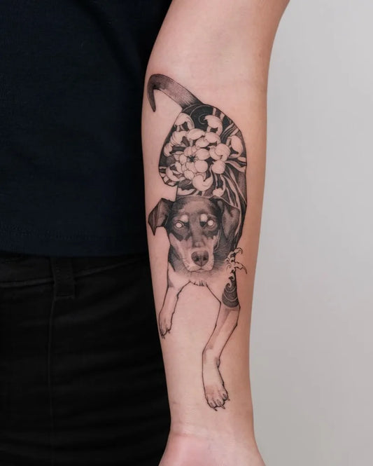 Medium Black and Grey Dog and Flowers Tattoo on Women Arm by @wilwang_tatt