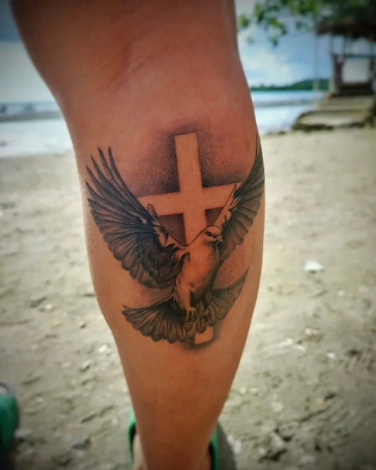 Medium Black and Grey Dove with Cross Tattoo on Women Knee by @superlativatruetothevolt