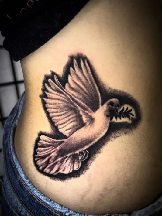 Medium Black and Grey Dove with Olive Branch Tattoo on Women Side by @iamjmart5