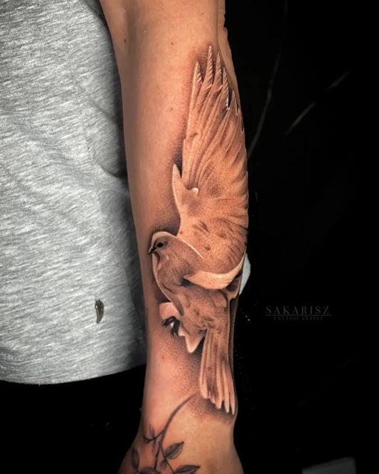 Medium Black and Grey Dove with Wings and Branch Tattoo on Women Arm by @sakarisz