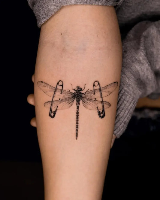 Medium Black and Grey Dragonfly with Safety Pins on Women on Forearm Tattoo by @_metatattoolab