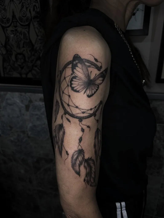 Medium Black and Grey Dream Catcher Butterfly Moon Tattoo on Women Arm by @fernealanatattoos