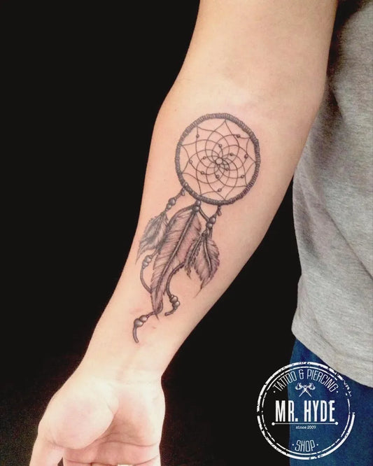 Medium Black and Grey Dream Catcher Feathers Tattoo on Men Arm by @mr.hydetattooshop