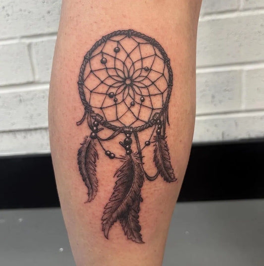 Medium Black and Grey Dream Catcher Tattoo on Women Leg by @scallywagink