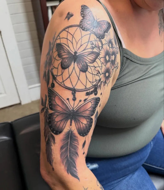 Medium Black and Grey Dream Catcher with Butterflies and Feathers Tattoo on Women Shoulder by @sincerelyctattoos