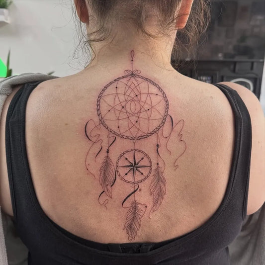 Medium Black and Grey Dream Catcher with Compass and Feathers Tattoo on Women Back by @stxphy__art