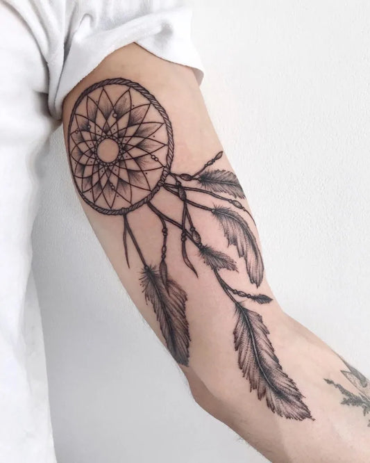 Medium Black and Grey Dream Catcher with Feathers Tattoo on Men Arm by @yg.tattooing