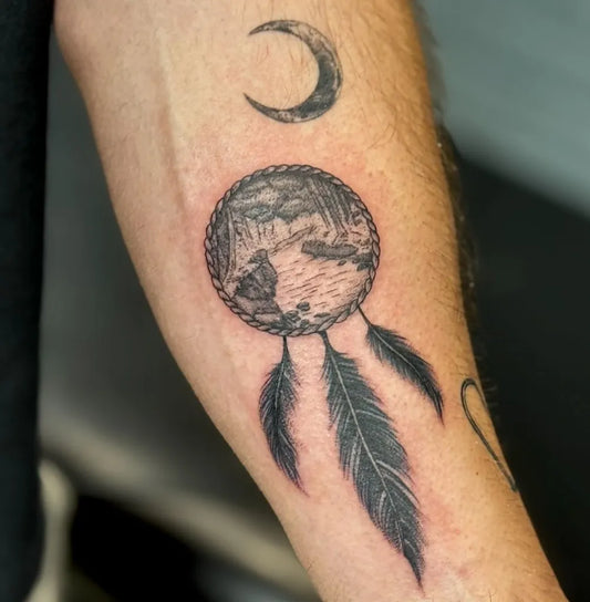 Medium Black and Grey Dream Catcher with Moon and Feathers Tattoo on Men Arm by @philwinsteadtattoos
