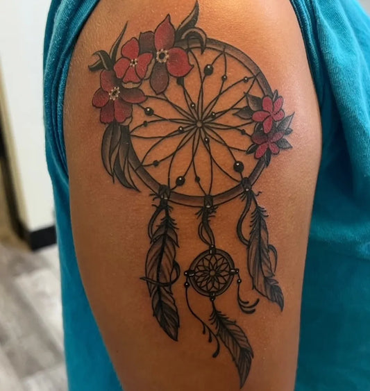 Medium Black and Grey Dream Catcher with Red Flowers Tattoo on Women Shoulder by @covina.tattoo.company