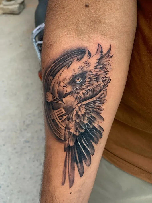 Medium Black and Grey Eagle Clock Tattoo on Men Arm by @ashish_____mali