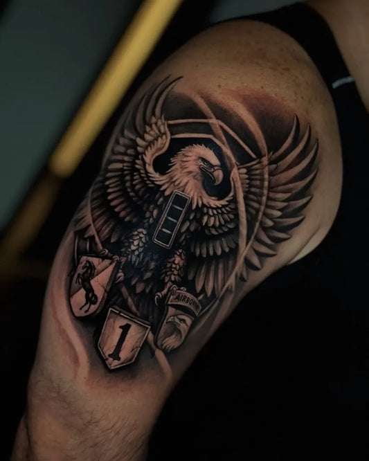 Medium Black and Grey Eagle Shield Tattoo on Men Bicep by @trilogyatelier