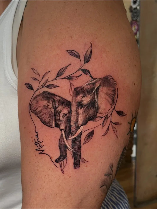 Medium Black and Grey Elephant Couple with Vines Tattoo on Men Arm by @jordan_f_inked