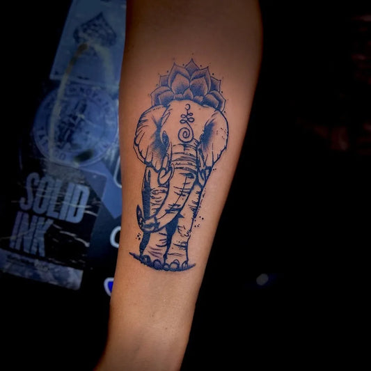 Medium Black and Grey Elephant Lotus Om Tattoo on Women Arm by @inkedinnovationstattoo