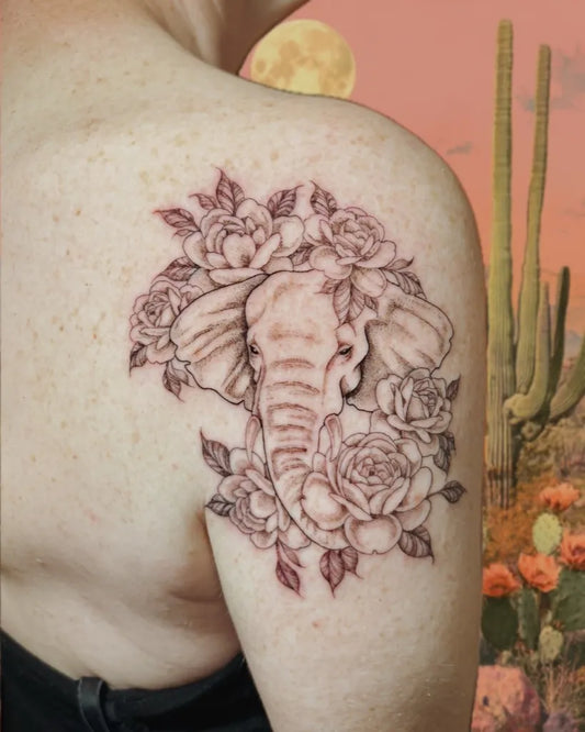 Medium Black and Grey Elephant and Roses Tattoo on Women Shoulder by @alejandrita.tattoo