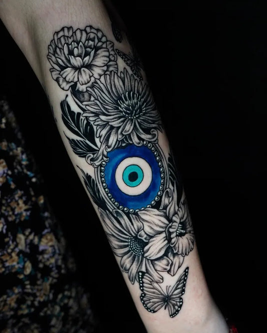 Medium Black and Grey Evil Eye Flowers on Women Arm Tattoo by @syfi.tattoos_sdt