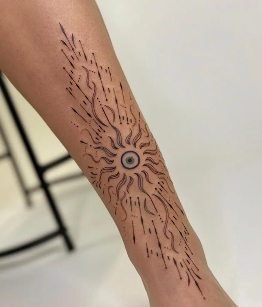 Medium Black and Grey Evil Eye Sun on Women Leg Tattoo by @tattlina