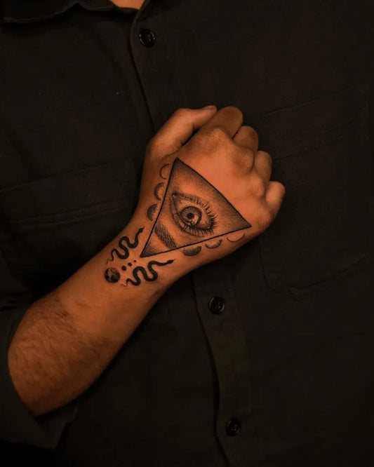 Medium Black and Grey Eye and Snake on Men Hand Tattoo by @vi_tattoo_studio_delhi