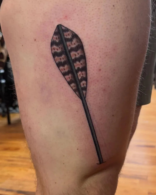 Medium Black and Grey Feather Arrow Tattoo on Men Thigh by @moira_mctaggert