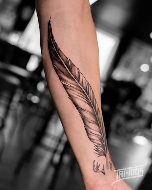 Medium Black and Grey Feather Tattoo on Men Arm by @tai.toos