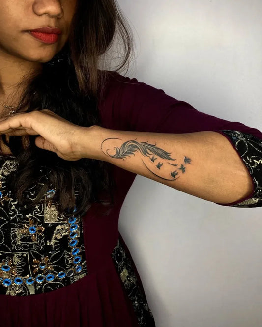 Medium Black and Grey Feather Tattoo on Women Arm by @skull_and_sword_tattoos